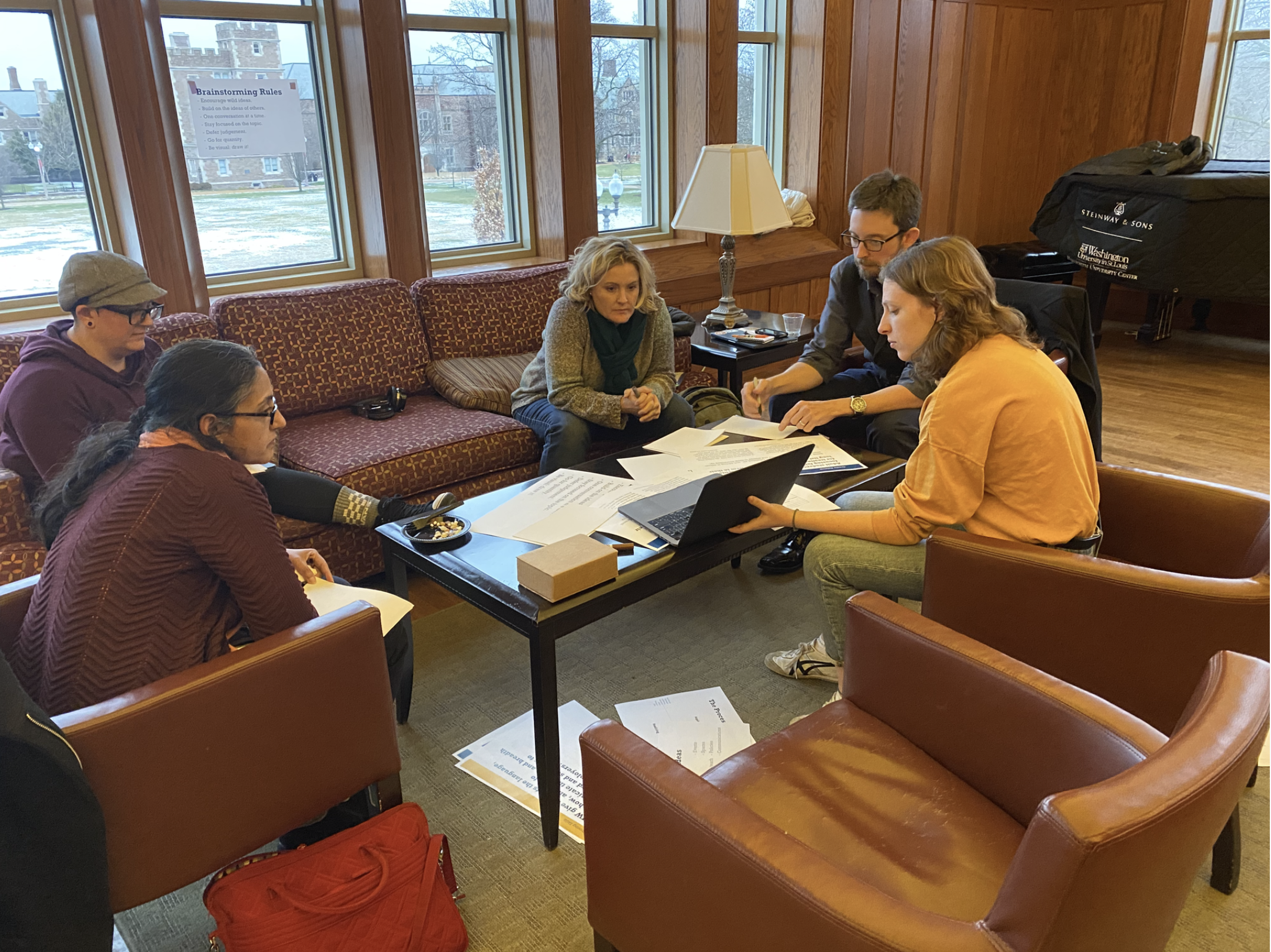 Woman facilitating an activity with multiple participants sitting around a table